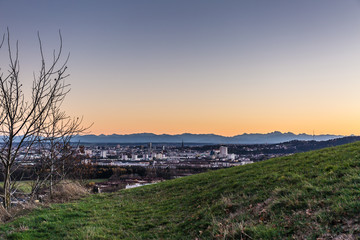 skyline of Linz, Austria with mountains at sun dawn