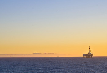 Oil Rig platform off Huntington Beach, California in Pacific ocean symbolizes global warming and environmental issues