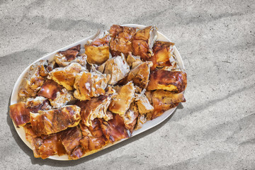 Plateful of Spit Roasted Pork Slices On Gray Manila Kraft Paper