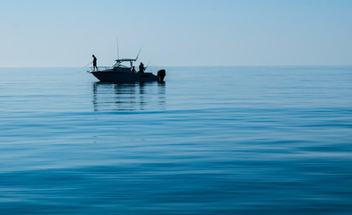 Silhouette of Sport Fishing boat in calm water - 122890742