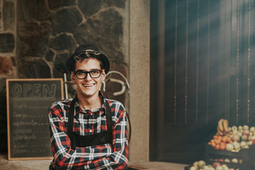 portrait of a smiling shopkeeper in a greengrocer