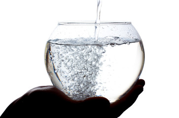 Water is poured into a large glass