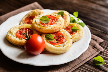 Small pizzas with Camembert cheese, tomato and herbs