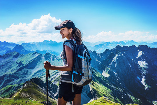 Attractive young woman trekking in the Alps