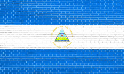 Flag of Nicaragua on brick wall texture background