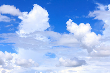 Obraz na płótnie Canvas Blue sky background with white clouds and rain clouds. The vast blue sky and clouds sky on sunny day. White fluffy clouds in the blue sky.