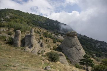 Low clouds on slope of the Demerdji mountain. The rock formations in Valley of Ghosts. Landscape of Crimea, Russia. Ukraine