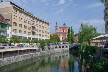 Fototapeta na wymiar Old town embankment in Ljubljana with the franciscan church of annunciation. Slovenia