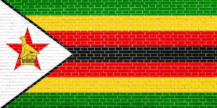 Flag of Zimbabwe on brick wall texture background