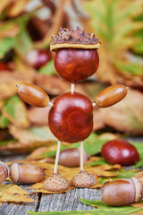 Small creature made of chestnuts and acorns. Autumnal decoration