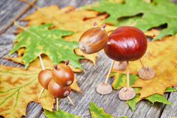 Small creatures made of chestnuts and acorns. Autumnal decoratio
