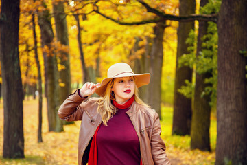 Woman in autumn park.
