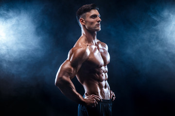 Strong bodybuilder man with perfect abs, shoulders,biceps, triceps, chest.