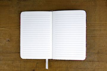 open empty notebook on wooden background