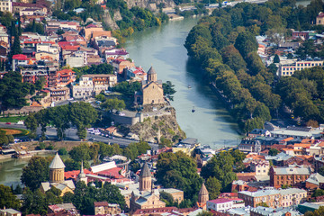 Aerial view of Tbilisi city with Kura river and Metekhi church o