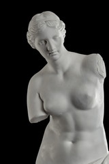 a statue of Venus, plaster column on a black background