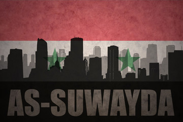 Fototapeta premium abstract silhouette of the city with text As-Suwayda at the vintage syrian flag background
