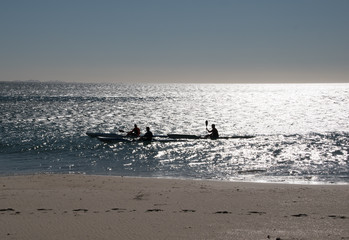Naklejka premium Kayakers in Silhouette
