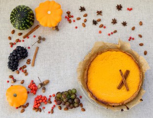 Fresh orange homemade pumpkin pie on rustic table, Thanksgiving.
