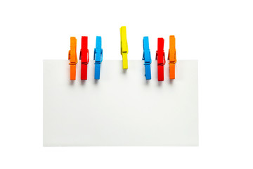 close up of a note paper and clothes pegs isolated on white background
