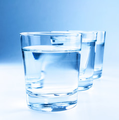 three drink glasses with water, nutrition and health-care concept