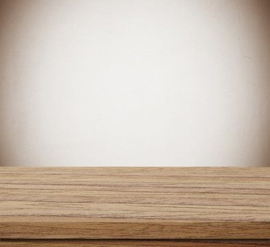 Empty wooden table over blue cement wall  background