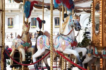 Fototapeta na wymiar Beautiful white horses on a merry go round