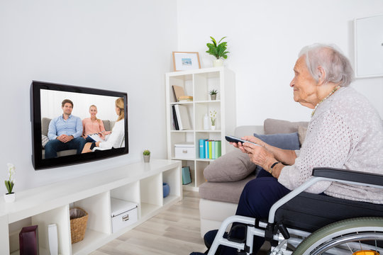 Handicapped Grandmother Watching Movie On Television
