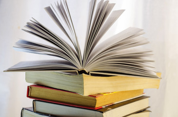stack of books and opened book