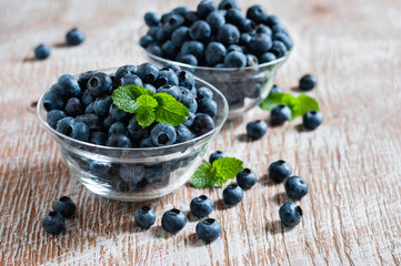 Blueberries in bowls, rustic style, wooden background, selective focus