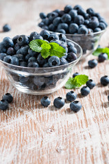 Blueberries in bowls, rustic style, wooden background, selective focus
