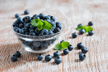 Blueberries in bowls, rustic style, wooden background, selective focus