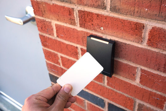 using white entrance card at door entrance card reader