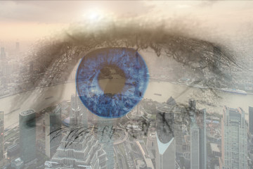 Double exposure image of human eye with business center district