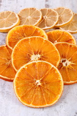 Slices of dried lemon and orange on old wooden background