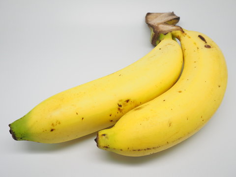 Fully riped yellow thai banana on white screen with exclamation mark on skin