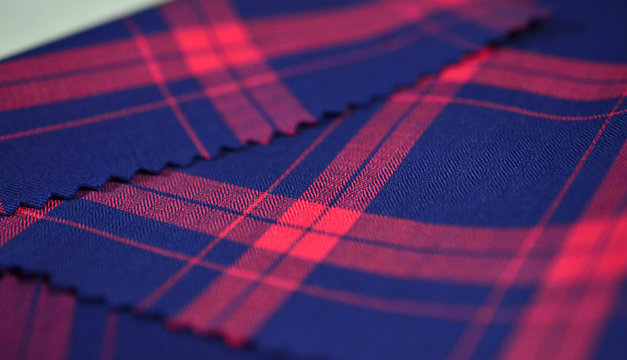 close up dark blue and red scott pattern fabric of shirt