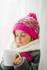 Cute little girl in fashionable winter clothes