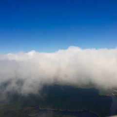 Fototapeta premium billowy clouds over a lush white and golden landscape