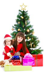 Obraz na płótnie Canvas Mother with daughter near the Christmas tree
