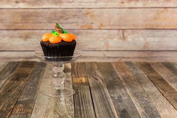 Pumpkin cupcake on a glass stand