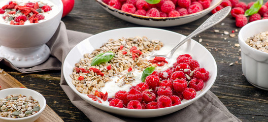 Healthy breakfast. Muesli, goji berries, yogurt on rustic wooden