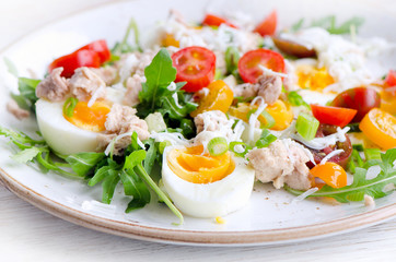 Fish salad with eggs and tomatoes.