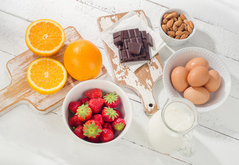 Allergic foods on a white wooden table.