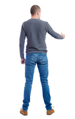 Back side view of man  in shirt handshake.  Rear view people collection.  backside view of person.  Isolated over white background. A guy in a gray sweater holds out his hand in greeting.