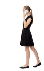 Fototapeta premium side view of a woman walking with a mobile phone. back view ofgirl in motion. backside view of person. Rear view people collection. Isolated over white background. The girl in a black dress talking