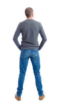 Back view of man in jeans. Standing young guy. Rear view people collection.  backside view of person.  Isolated over white background.  A guy in a gray sweater standing with folded hands in his