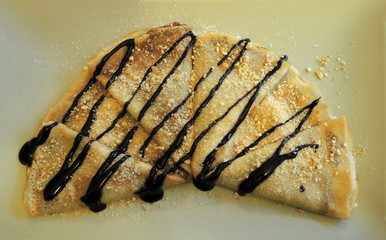 Delicious sweet pancakes covered with chocolate 