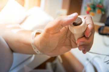 Patient hand pressing emergency nurse call button with selective