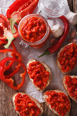 Appetizer ajvar from peppers with garlic close-up. Vertical top view
